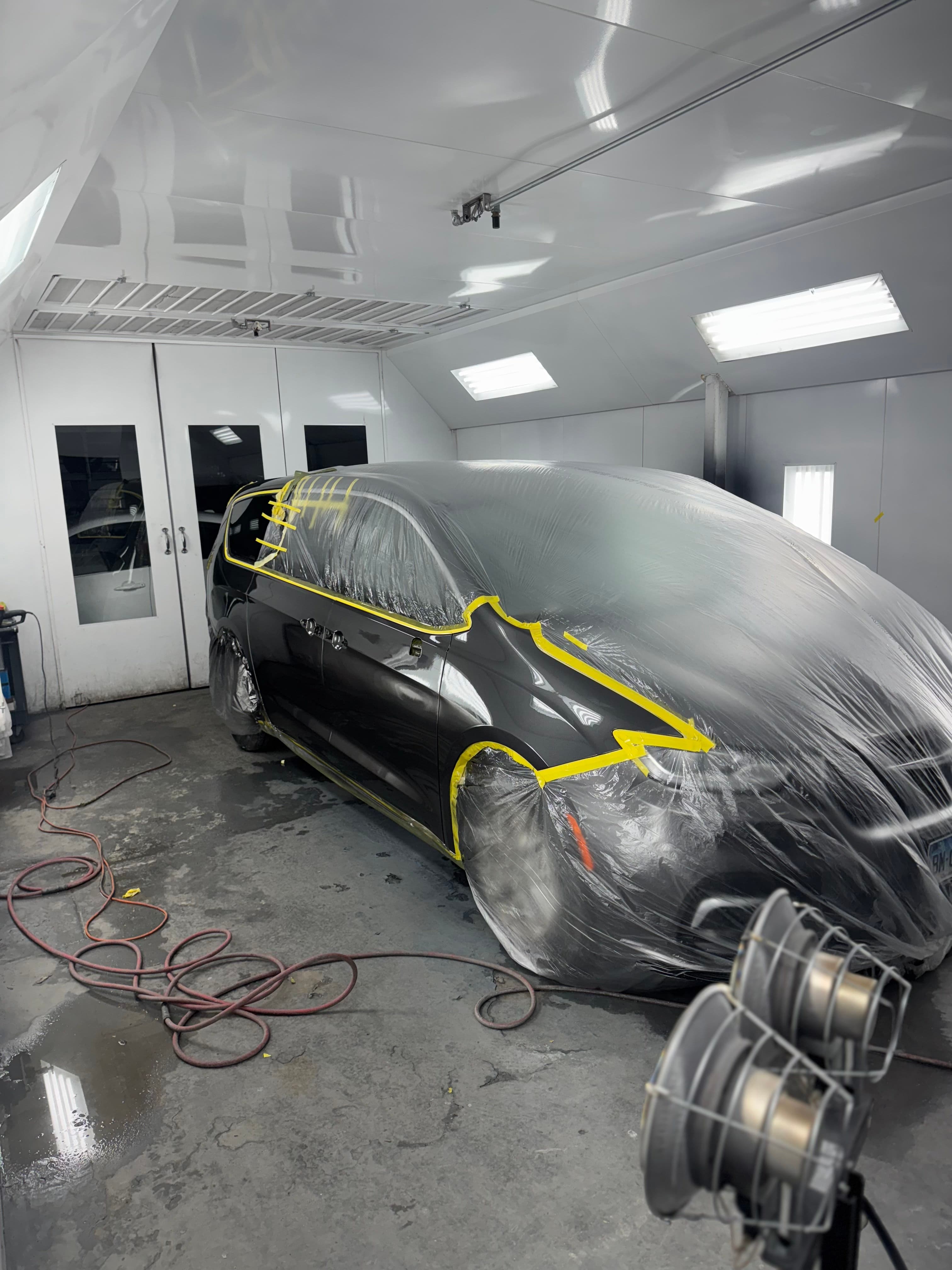 Black sedan masked for front fender and bumper refinishing at D&S Auto Repair in Vallejo, CA