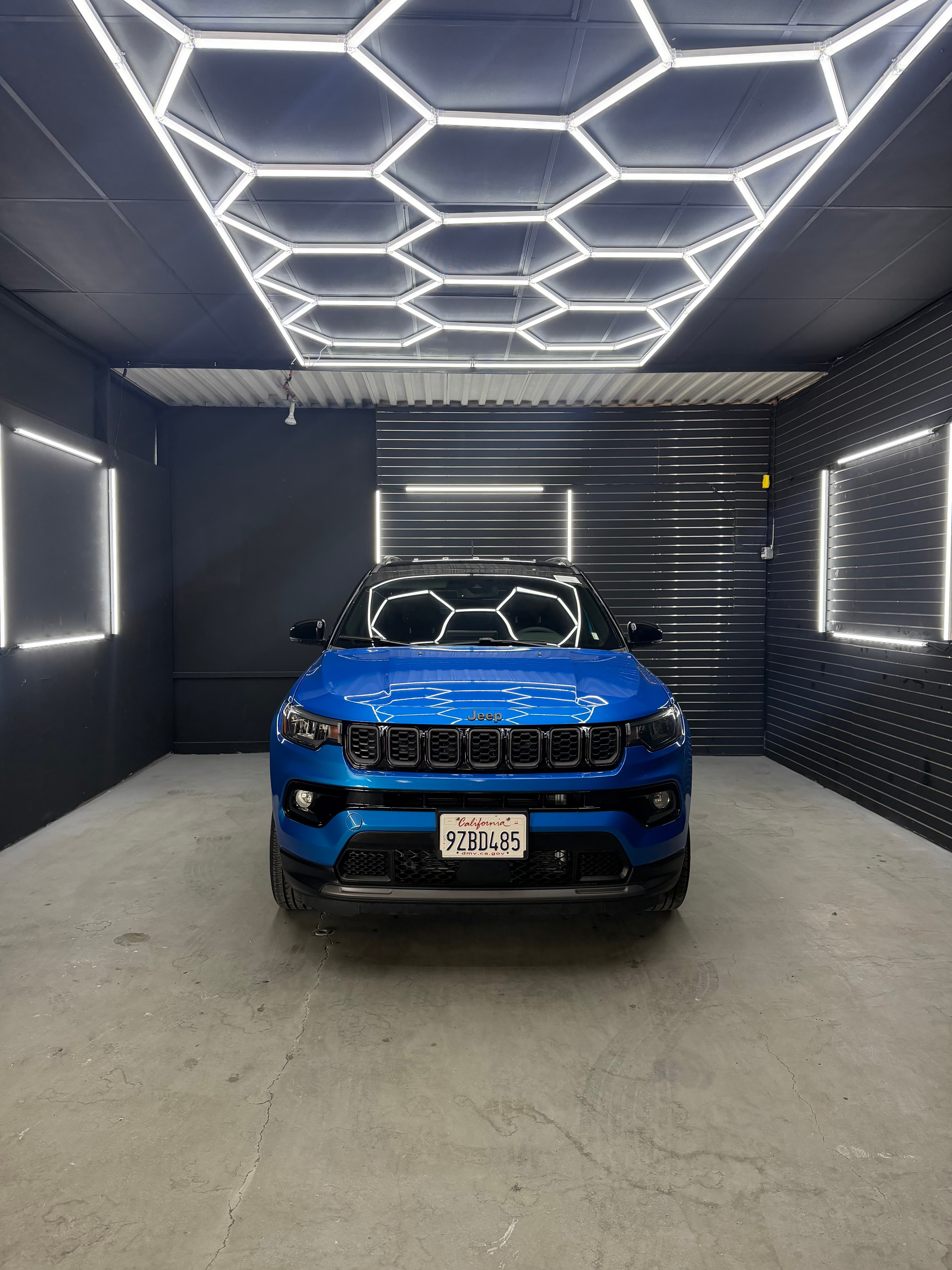 Blue Jeep Compass finished under hex lighting at D&S Auto Repair in Vallejo, CA